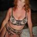Enchanting Eyes, a Utah escort, seated in black and beige lace lingerie.