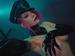 Miss Vicious, an SLC femdom Mistress, wears black latex gloves and a peaked cap.